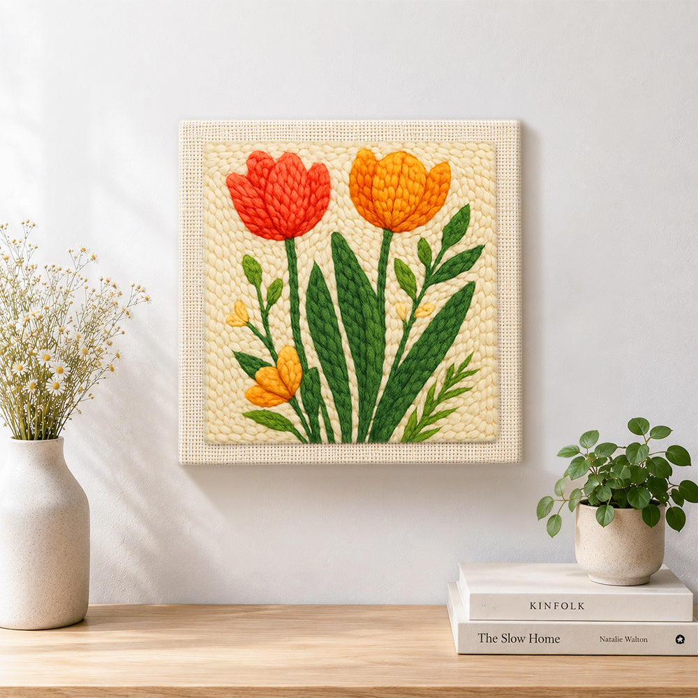 Finished red and orange tulips on the creamy background artwork displayed on a wall