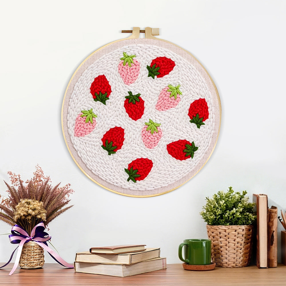 Finished red and pink strawberries artwork displayed on a wall