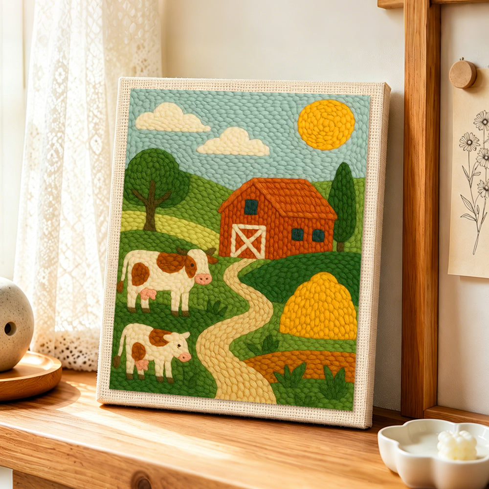 Red barn and cows landscape punch needle artwork displayed on a table