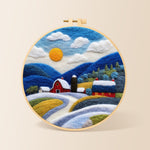 Red barn and snowy blue hills needle felting kit for beginners with a round wooden frame