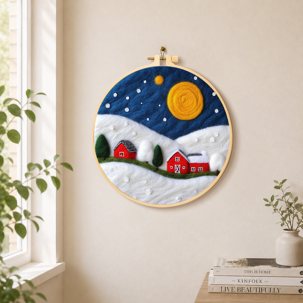 Red barns under the giant golden moon needle felt wall art displayed in a bright home interior
