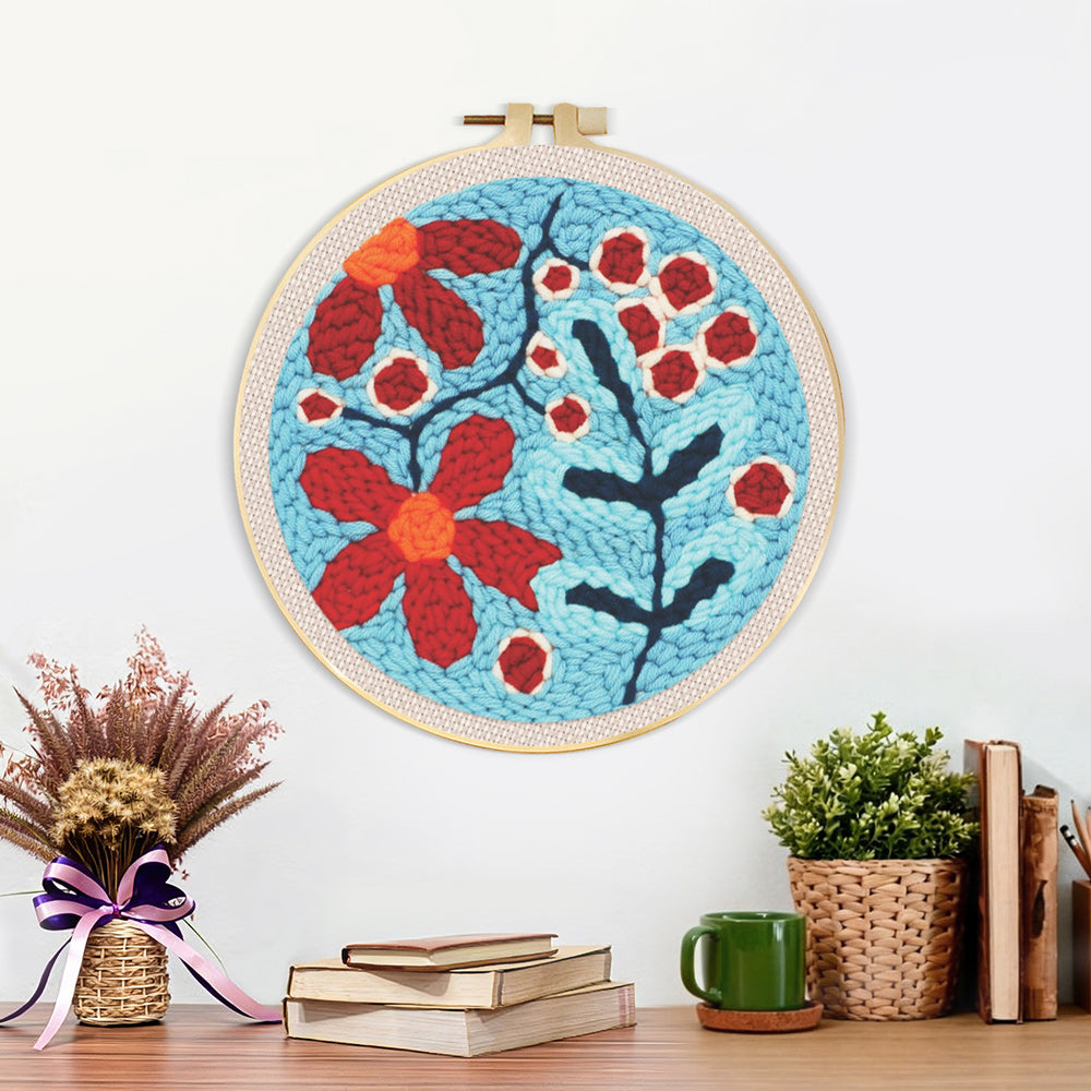 Finished red berries and flowers artwork displayed on a wall