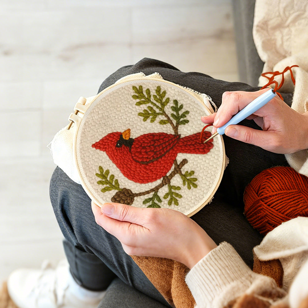 Creating handmade red cardinal and pine cone branch punch needle artwork