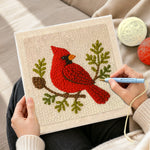 Creating handmade red cardinal on a branch punch needle artwork