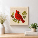 Finished red cardinal on a branch artwork displayed on a wall