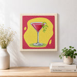 Finished red cocktail with lime artwork displayed on a wall