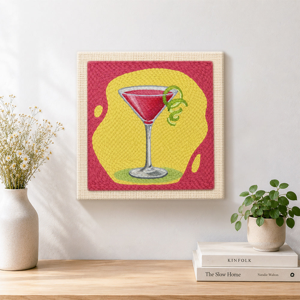 Finished red cocktail with lime artwork displayed on a wall