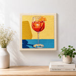 Finished red drink with orange slice artwork displayed on a wall