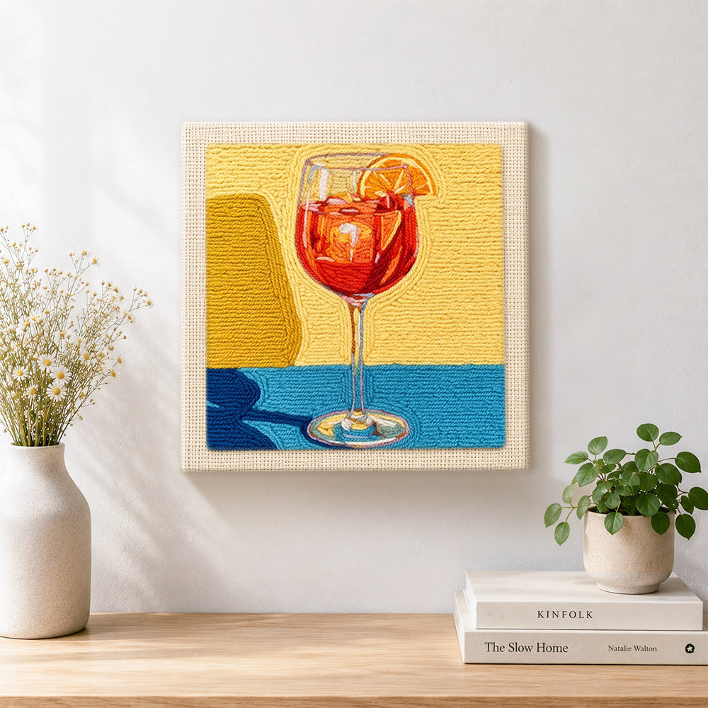 Finished red drink with orange slice artwork displayed on a wall