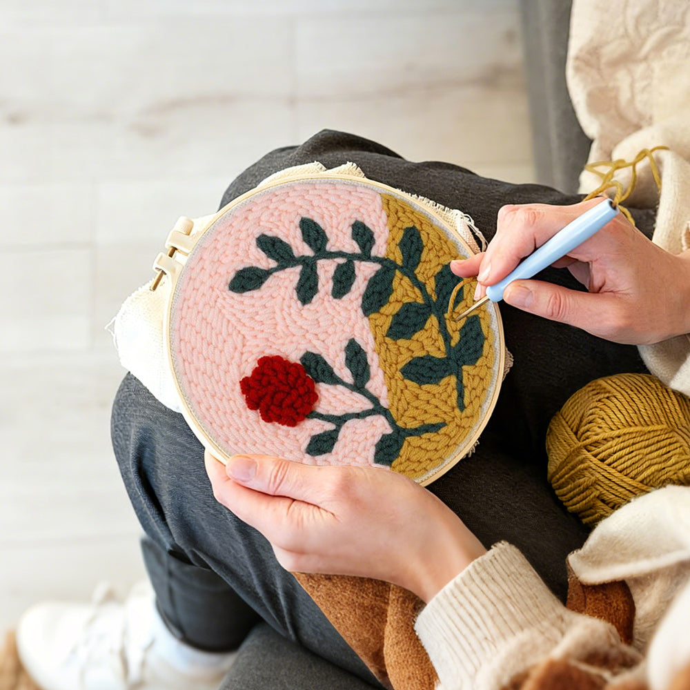 Creating handmade red flower and green leaves punch needle artwork