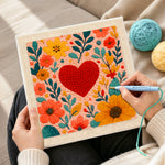 Creating handmade red heart surrounded by colourful blooms punch needle artwork
