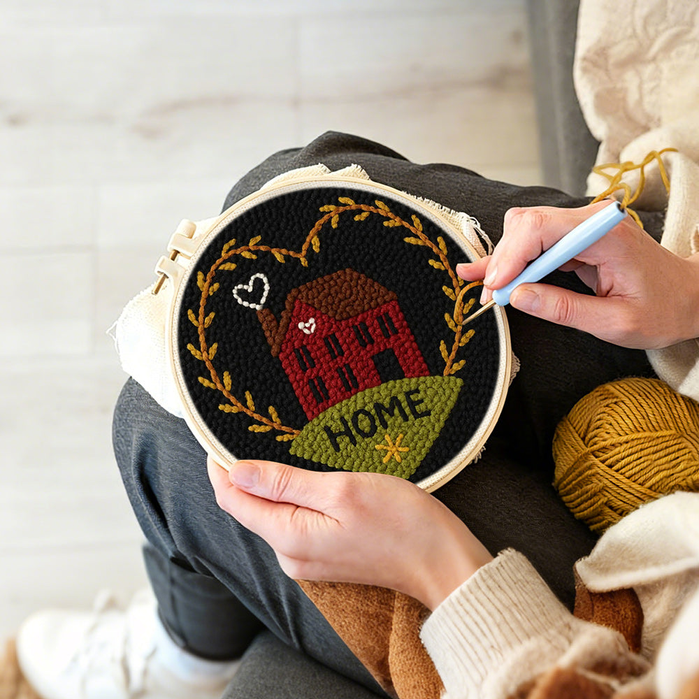 Creating handmade red house with “home” heart wreath punch needle artwork