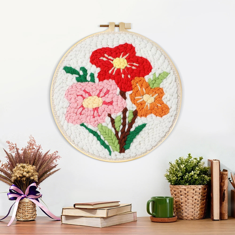 Finished red, pink and orange floral bouquet artwork displayed on a wall