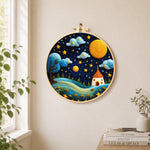 Red-roof fairy house under the magical night sky needle felt wall art displayed in a bright home interior