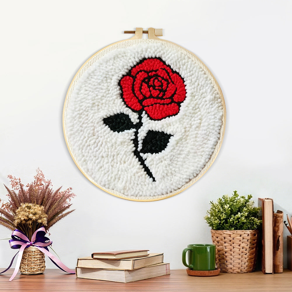 Finished red rose on white background artwork displayed on a wall