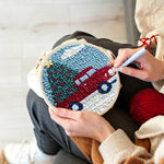 Creating handmade red truck hauling christmas tree punch needle artwork