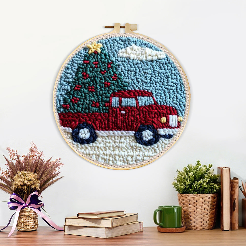 Finished red truck hauling christmas tree artwork displayed on a wall