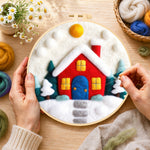 Creating the ed winter house with blue door wool painting by hand with a felting needle