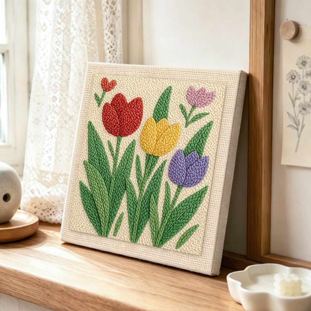 Red, yellow and purple tulip flowers punch needle artwork displayed on a table