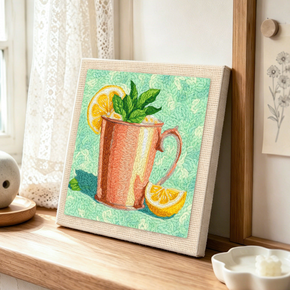 Refreshing mint and lemon drink punch needle artwork displayed on a table