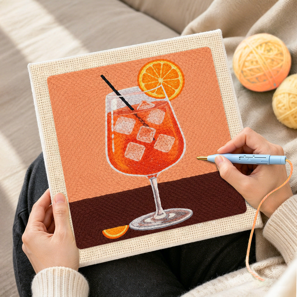 Creating handmade refreshing orange cocktail with ice cubes punch needle artwork