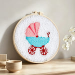 Retro baby pram punch needle artwork displayed on a table