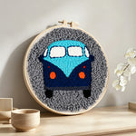 Retro blue campervan punch needle artwork displayed on a table