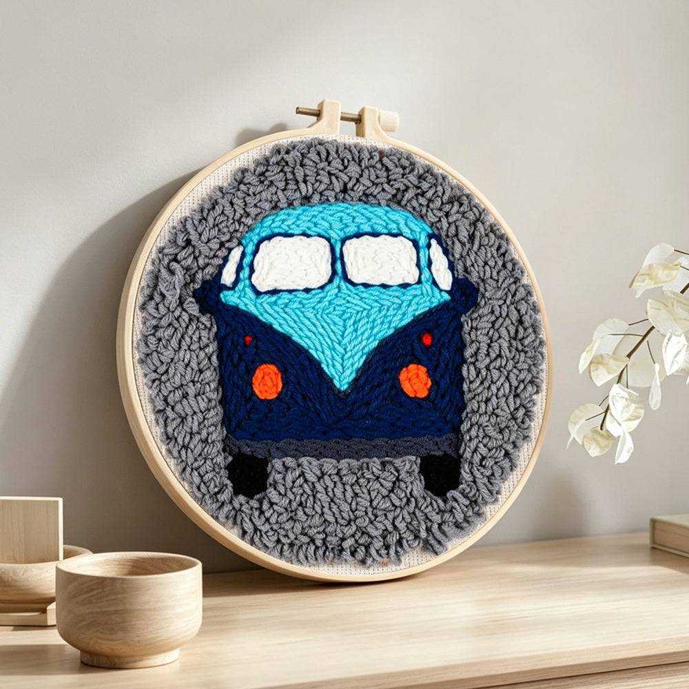 Retro blue campervan punch needle artwork displayed on a table