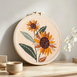 Retro earth tone sunflowers punch needle artwork displayed on a table