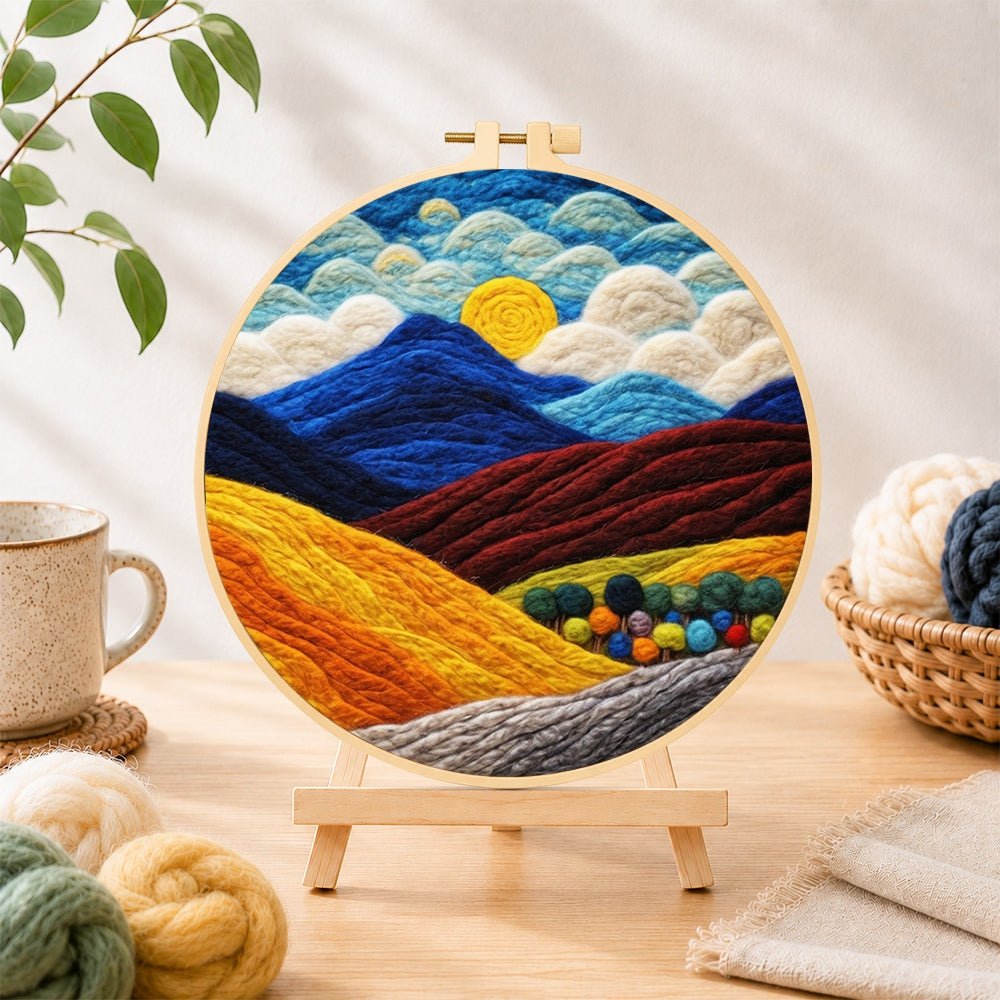 Finished rich autumn mountain scene needle felting displayed on a wooden easel