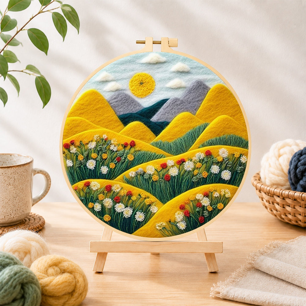 Finished rolling golden hills and daisies needle felting displayed on a wooden easel
