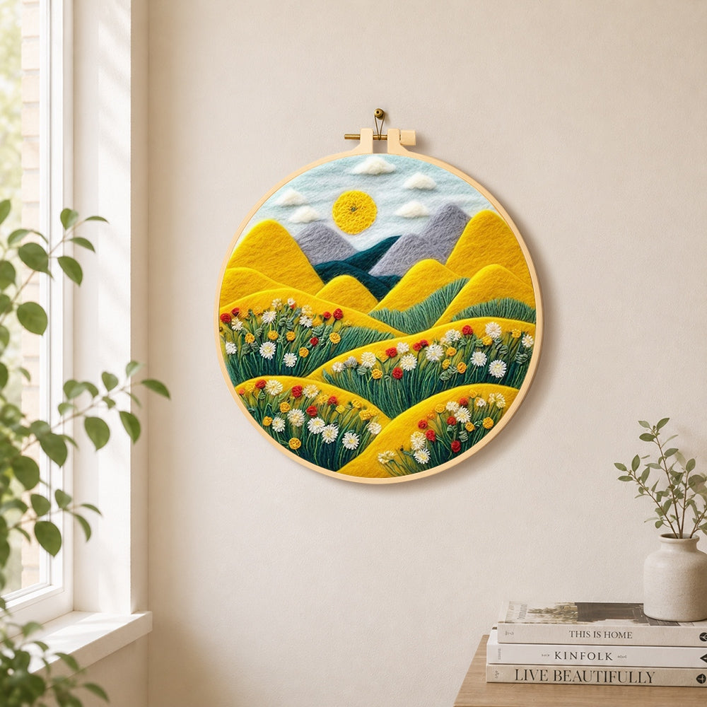 Rolling golden hills and daisies needle felt wall art displayed in a bright home interior