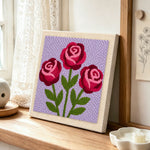 Romantic blooming roses punch needle artwork displayed on a table