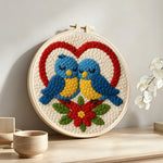 Romantic blue lovebirds punch needle artwork displayed on a table