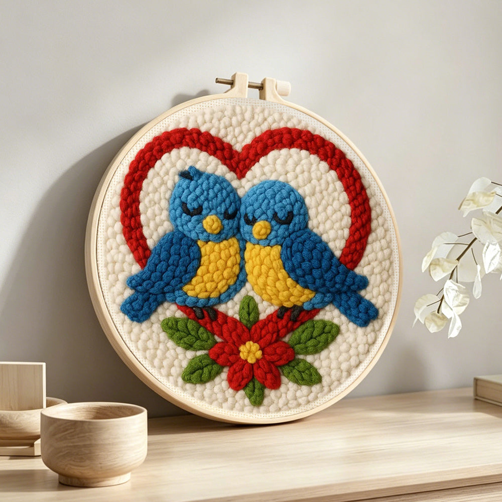 Romantic blue lovebirds punch needle artwork displayed on a table