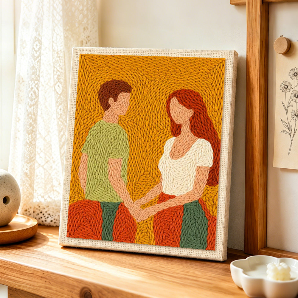 Romantic couple holding hands punch needle artwork displayed on a table