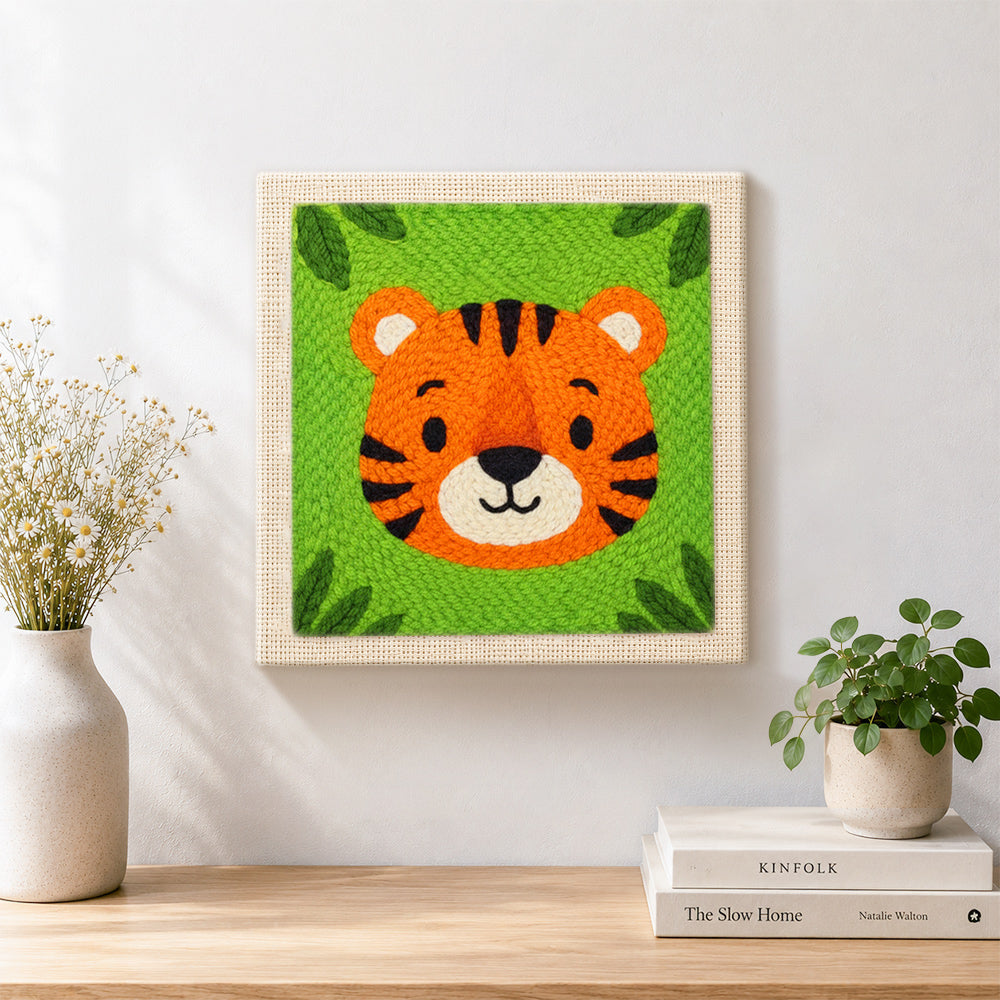 Finished round and cuddly tiger face artwork displayed on a wall