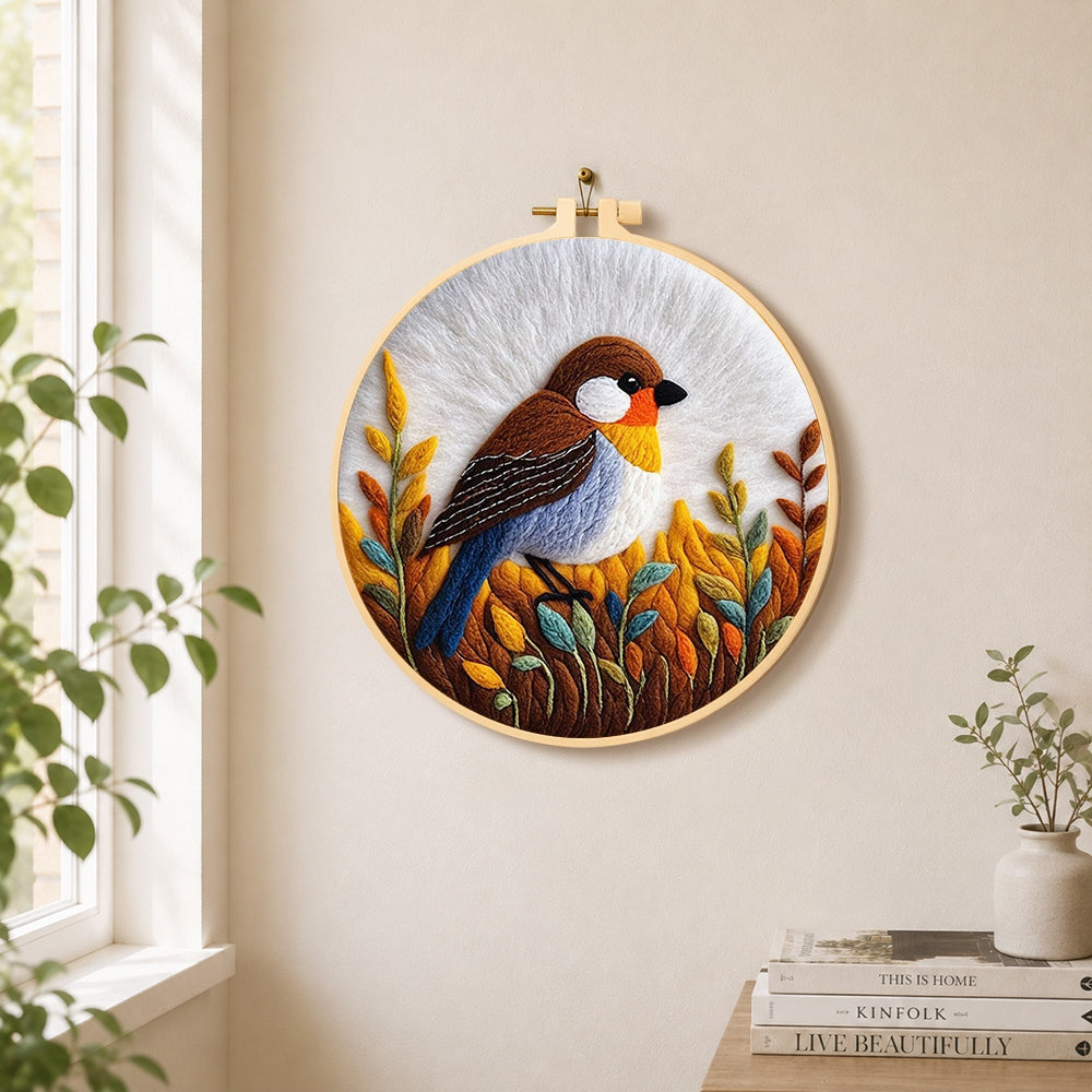 Rustic autumnal bird on golden grasses needle felt wall art displayed in a bright home interior