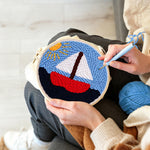 Creating handmade sailboat on the sea under the sunlight punch needle artwork