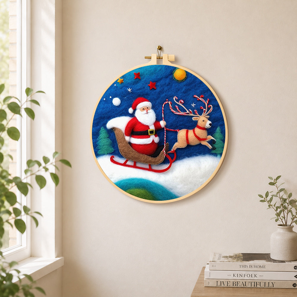 Santa in sleigh with reindeer needle felt wall art displayed in a bright home interior