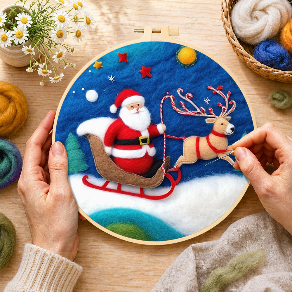 Creating the santa in sleigh with reindeer wool painting by hand with a felting needle