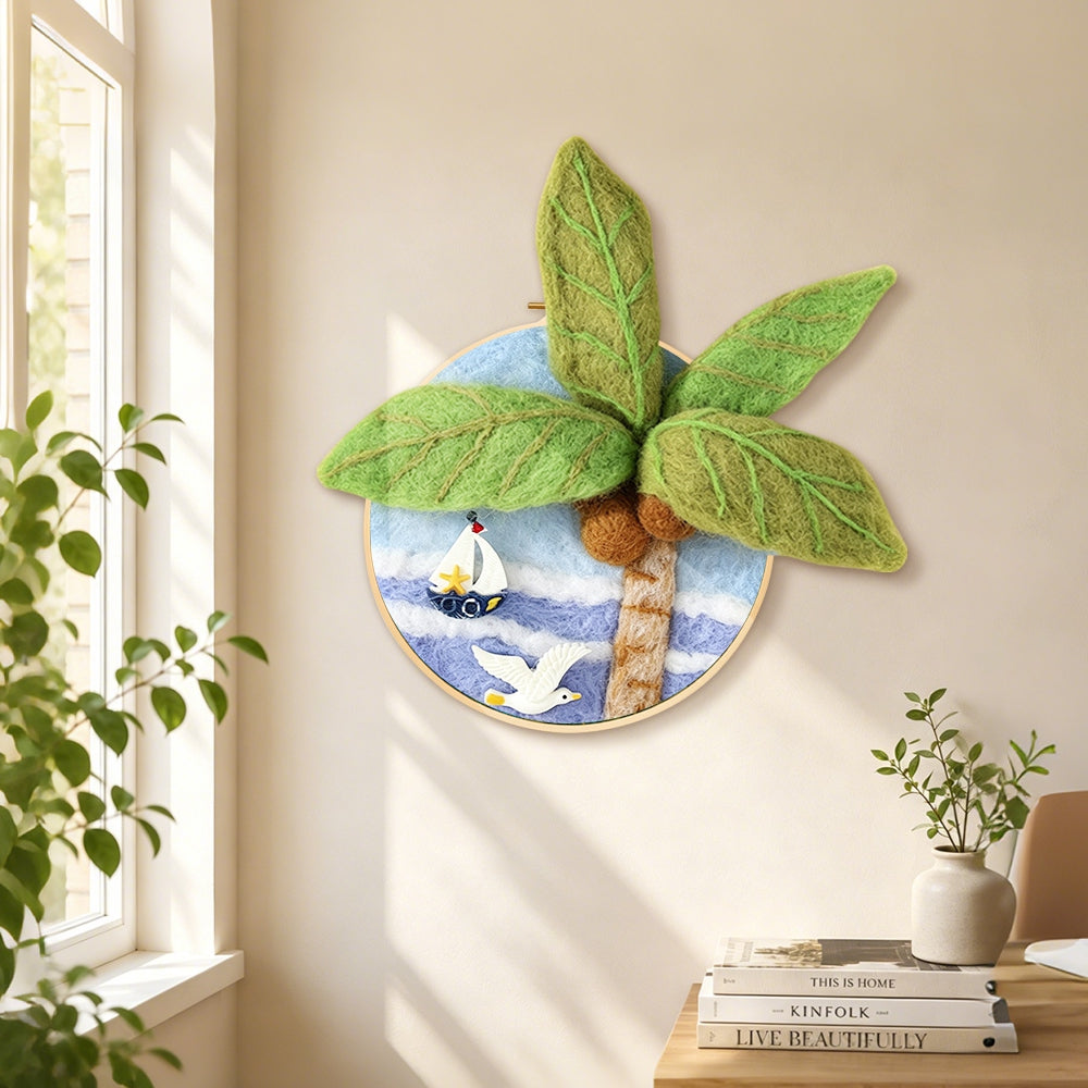 Seagull, palm tree and sailboat needle felt wall art displayed in a bright home interior