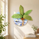 Seagull, palm tree and sailboat needle felt wall art displayed in a bright home interior