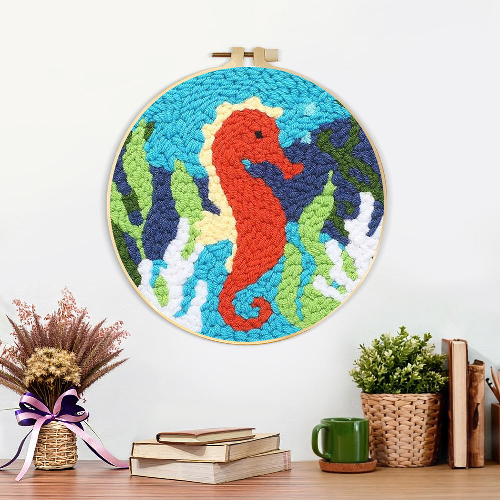 Finished seahorse and seaweed artwork displayed on a wall