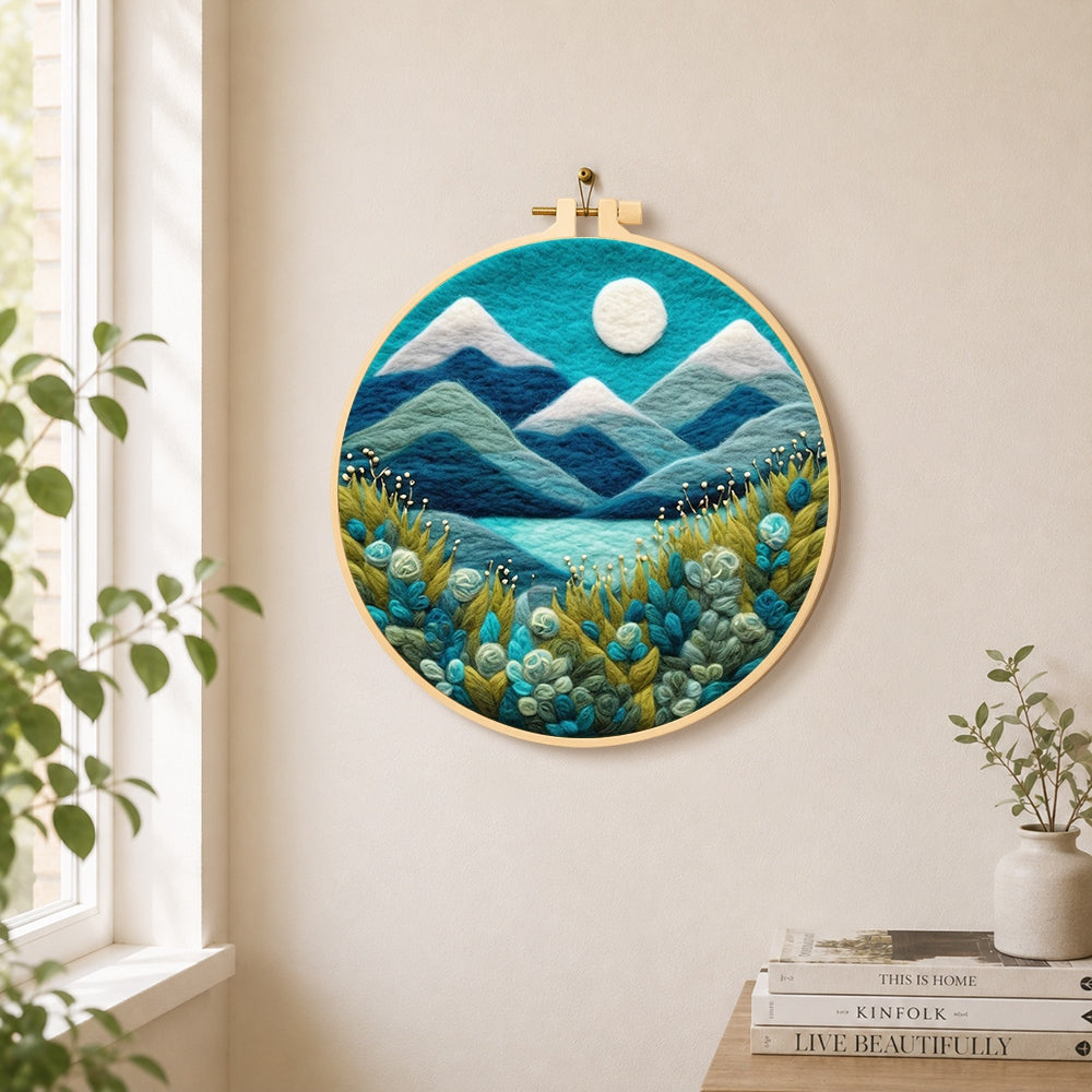 Serene blue mountain with textured floral foliage needle felt wall art displayed in a bright home interior