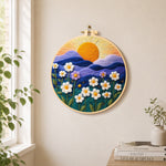 Serene mountain sunset and white daisies needle felt wall art displayed in a bright home interior