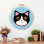 Finished serious cat artwork displayed on a wall