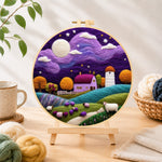 Finished sheep under the dreamy purple night sky needle felting displayed on a wooden easel