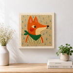 Finished side-profile fox with green scarf artwork displayed on a wall