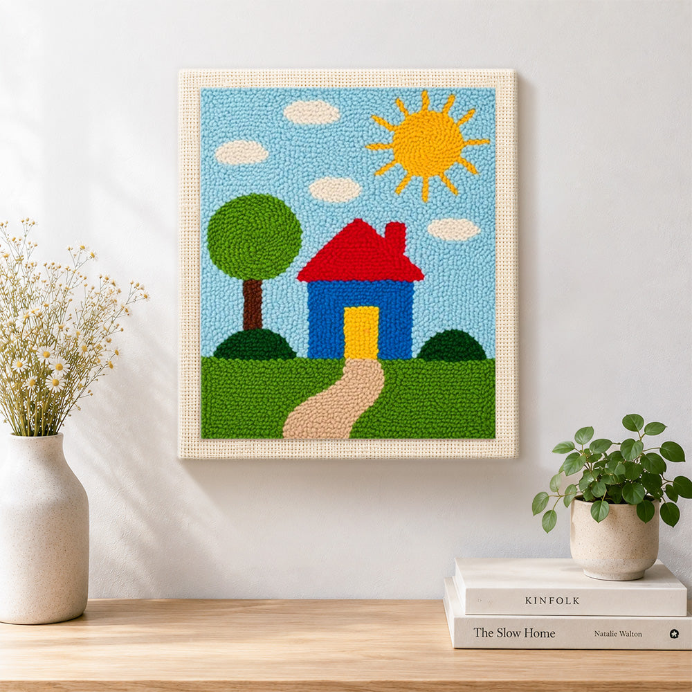 Finished simple sunny house and green tree artwork displayed on a wall